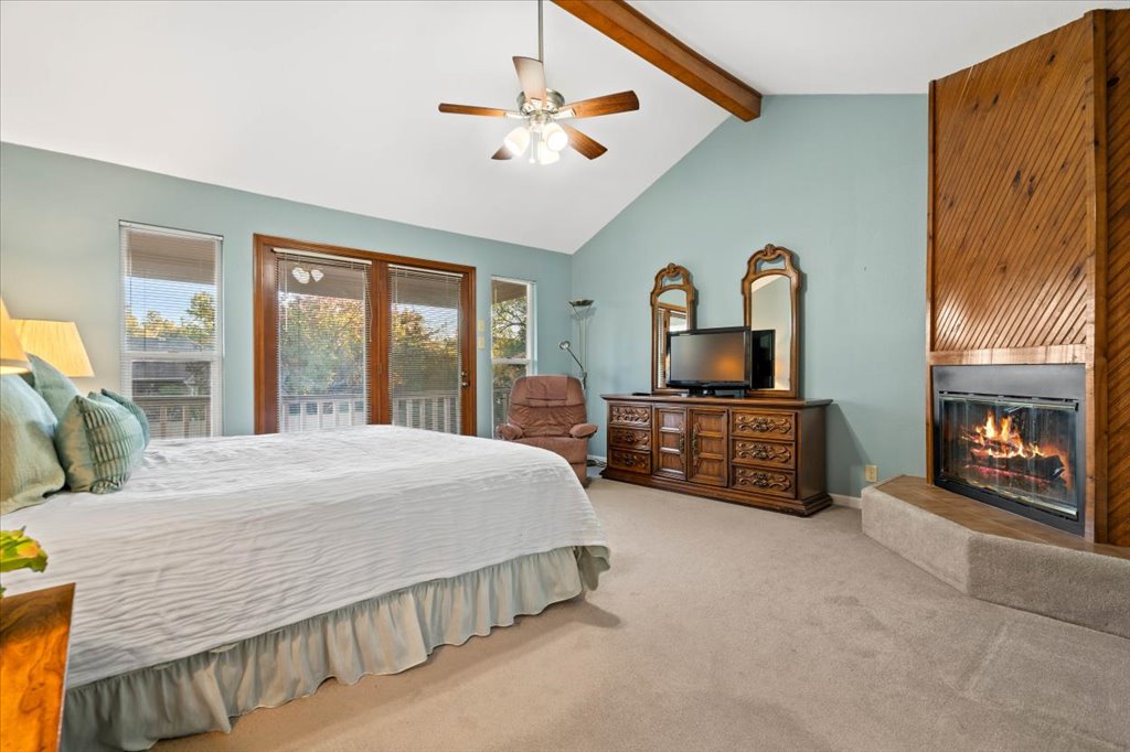 3803 Frodo Cove Austin, TX 78739 - Photo 21 of 40 a spacious bedroom with a bed a dresser next to a window