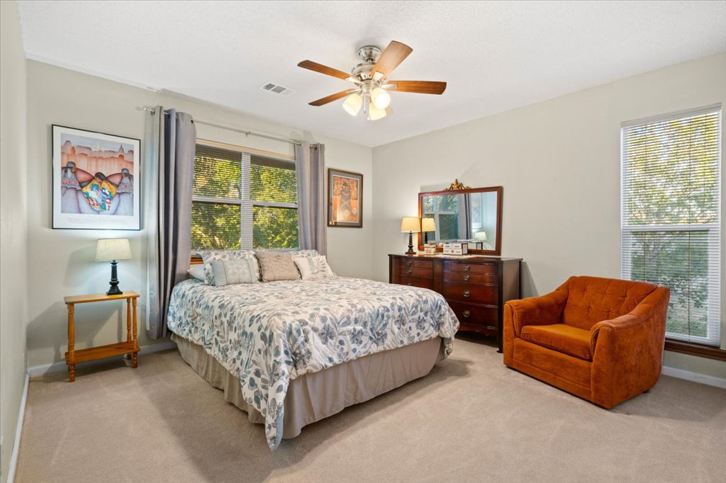 3803 Frodo Cove Austin, TX 78739 - Photo 27 of 40 a bedroom with bed and ceiling fan