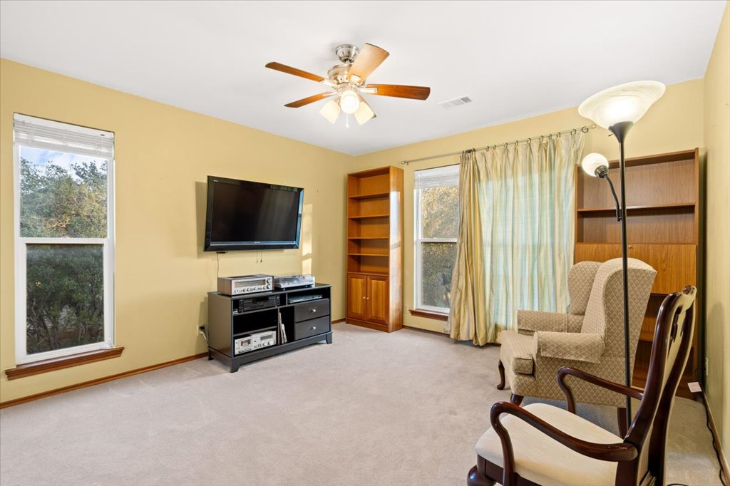 3803 Frodo Cove Austin, TX 78739 - Photo 29 of 40 a living room with furniture and a flat screen tv