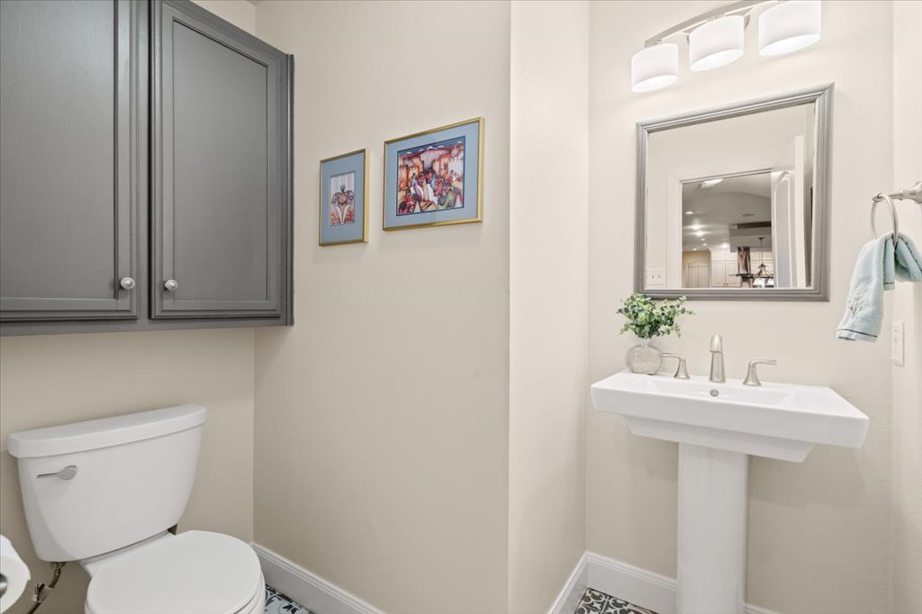 3803 Frodo Cove Austin, TX 78739 - Photo 33 of 40 a bathroom with a toilet a sink and mirror