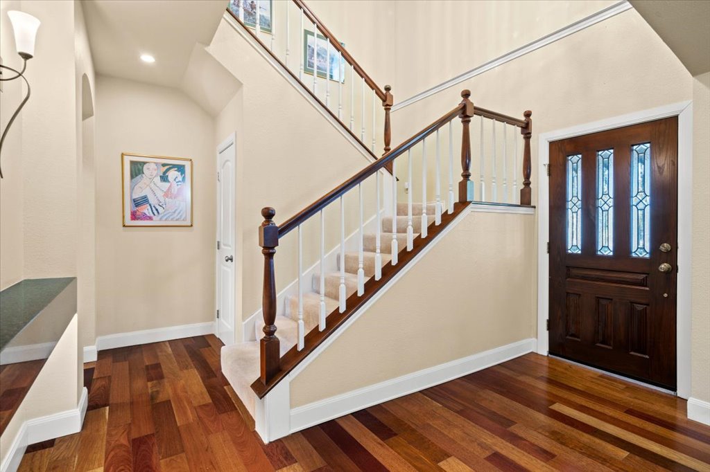 3803 Frodo Cove Austin, TX 78739 - Photo 7 of 40 a view of front door with wooden floor and stairs
