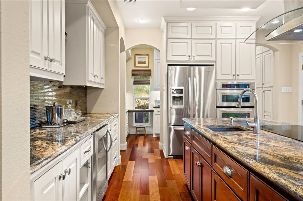 3803 Frodo Cove Austin, TX 78739 - Photo 10 of 40 a kitchen with stainless steel appliances granite countertop a refrigerator a stove and a sink