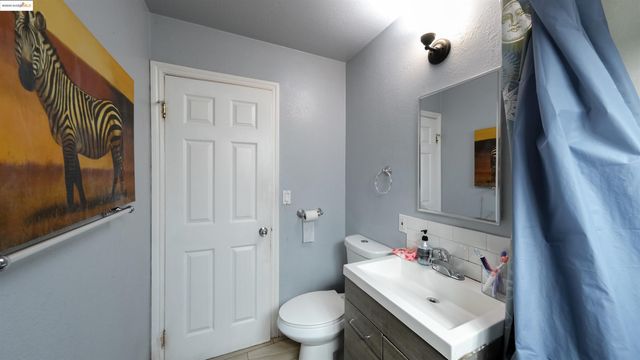 a bathroom with a sink toilet and mirror