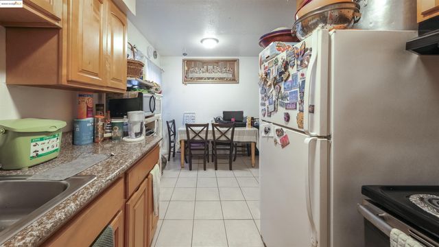 a kitchen with stainless steel appliances granite countertop a sink and a refrigerator