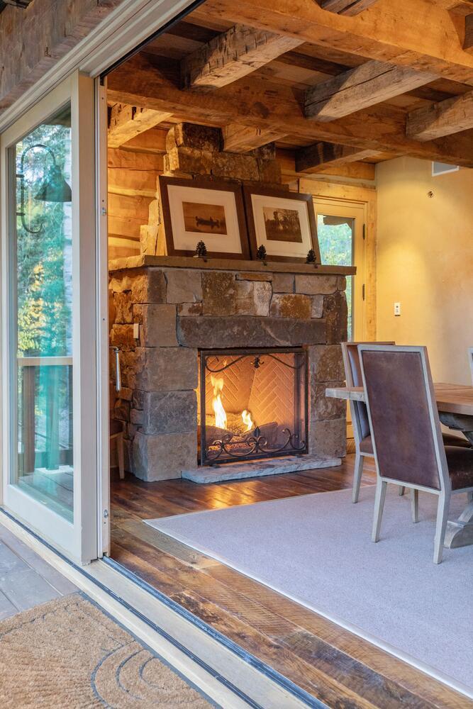 274 Benchmark Drive Mountain Village, CO 81435 - Photo 15 of 58 a living room with a fireplace and a wooden floor