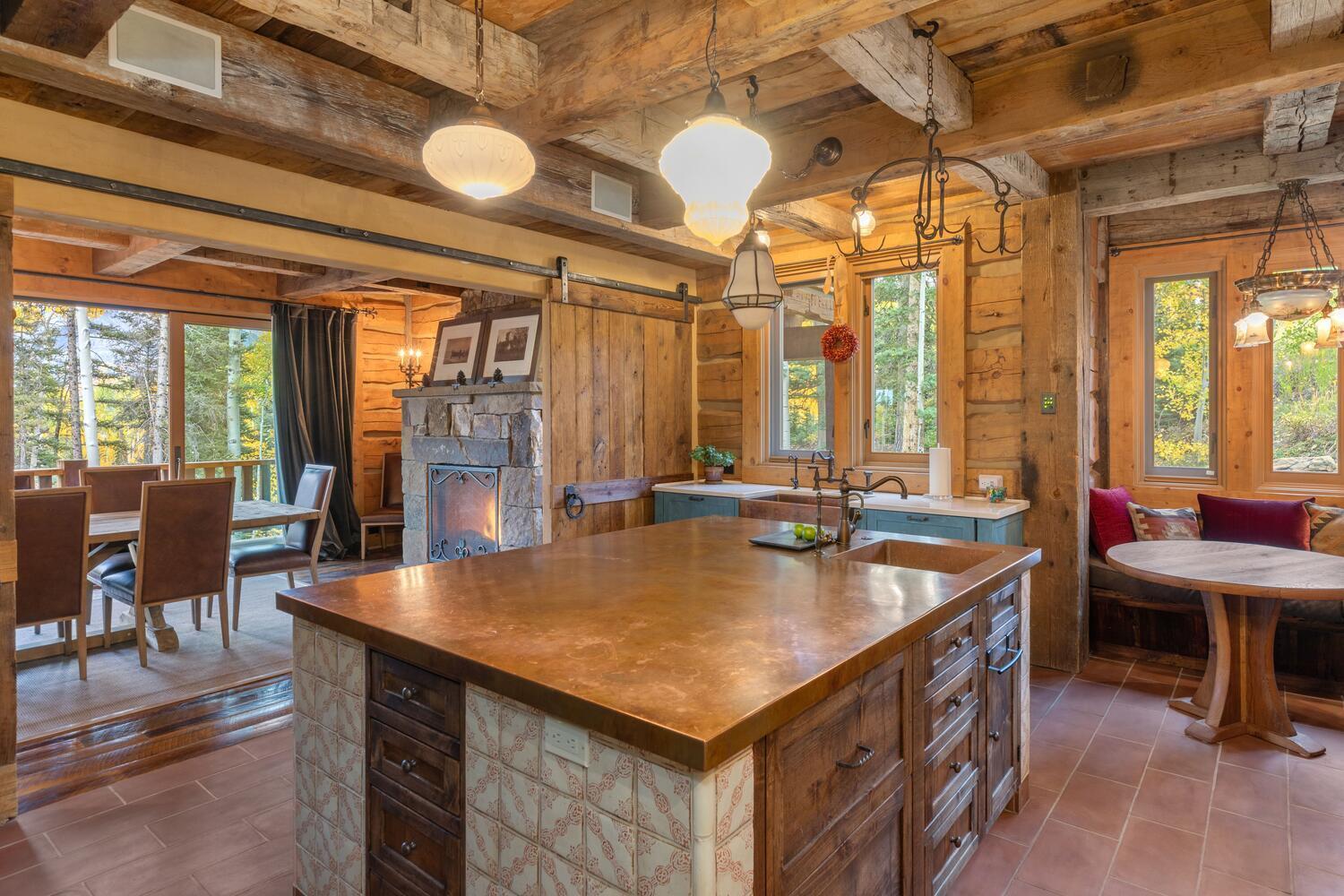 274 Benchmark Drive Mountain Village, CO 81435 - Photo 19 of 58 a kitchen with a table chairs and flat screen tv