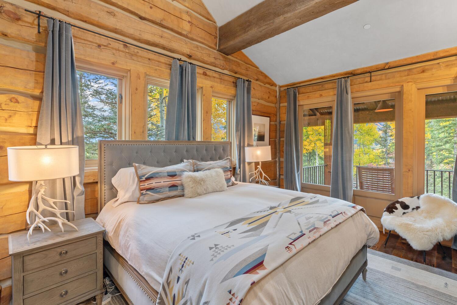 274 Benchmark Drive Mountain Village, CO 81435 - Photo 37 of 58 a bedroom with a large bed and two large window