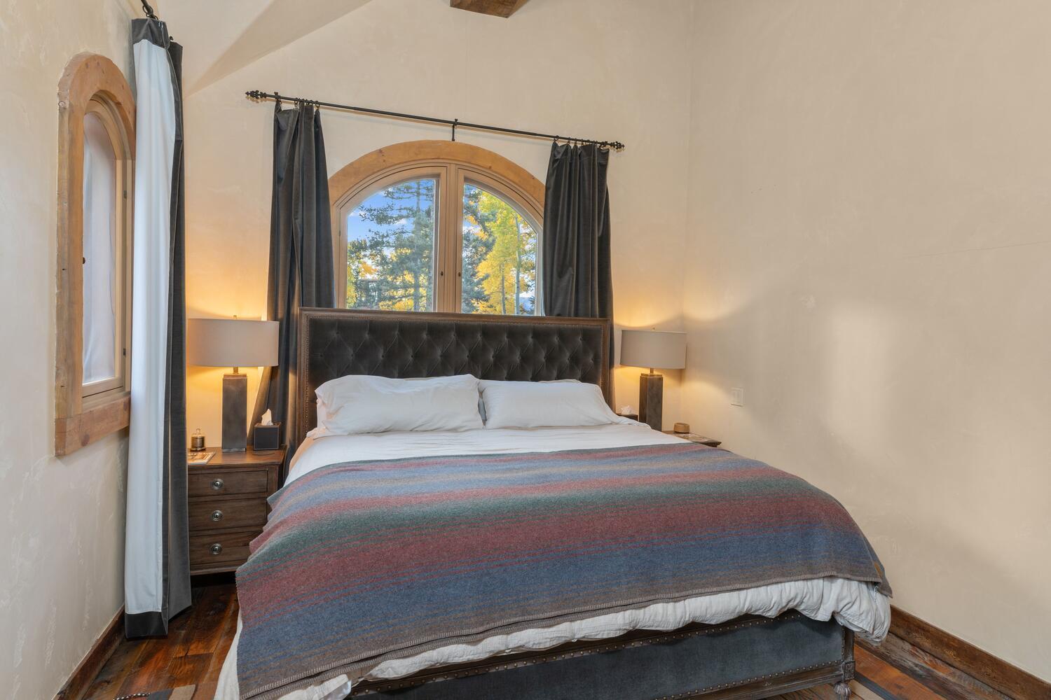 274 Benchmark Drive Mountain Village, CO 81435 - Photo 45 of 58 a bedroom with a bed a dresser and a window