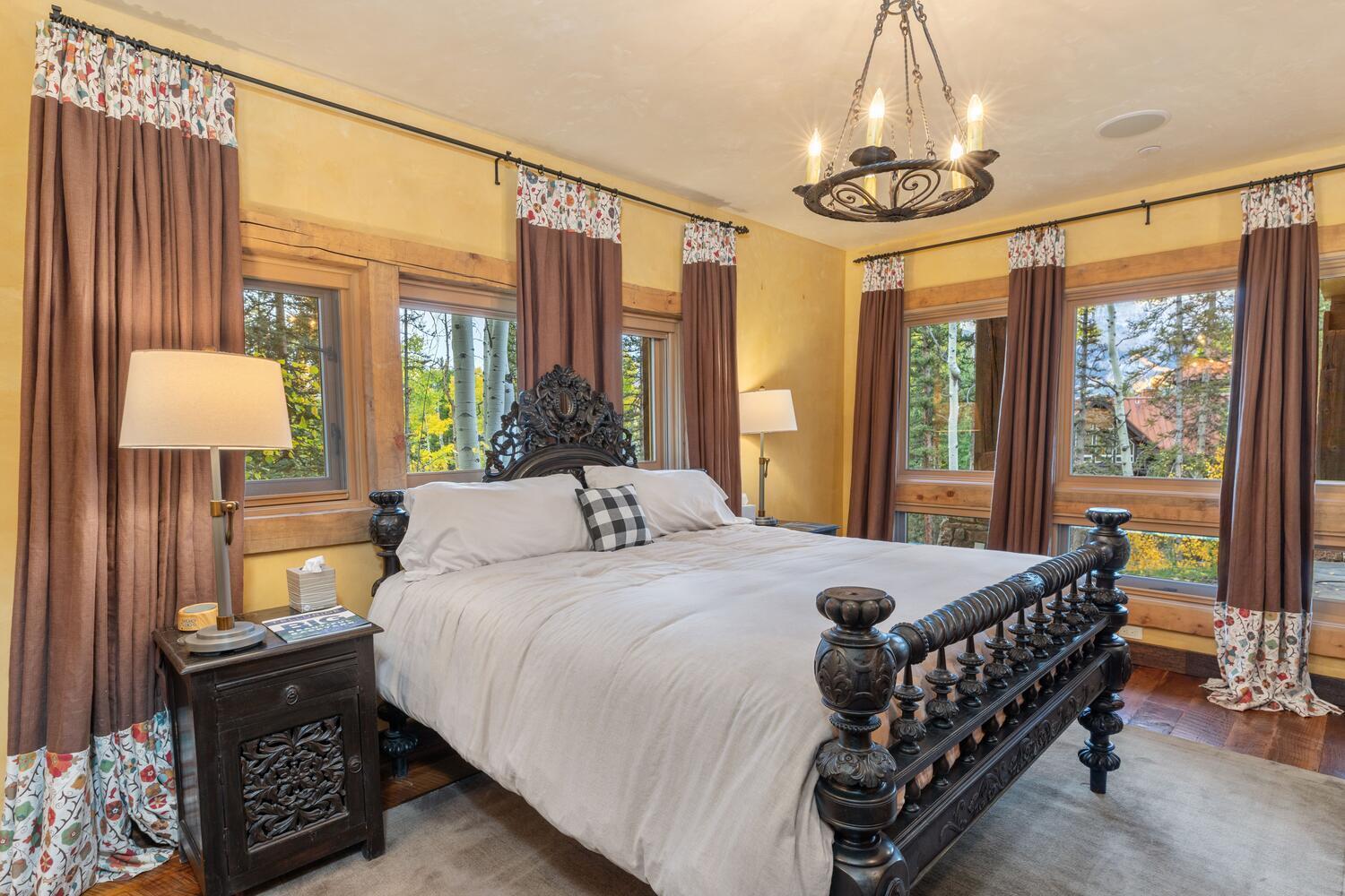 274 Benchmark Drive Mountain Village, CO 81435 - Photo 51 of 58 a bedroom with a bed and a chandelier