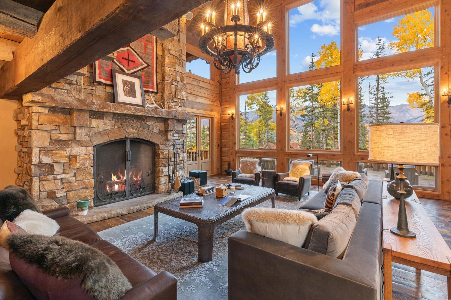 274 Benchmark Drive Mountain Village, CO 81435 - Photo 7 of 58 a living room with furniture a fireplace and floor to ceiling windows