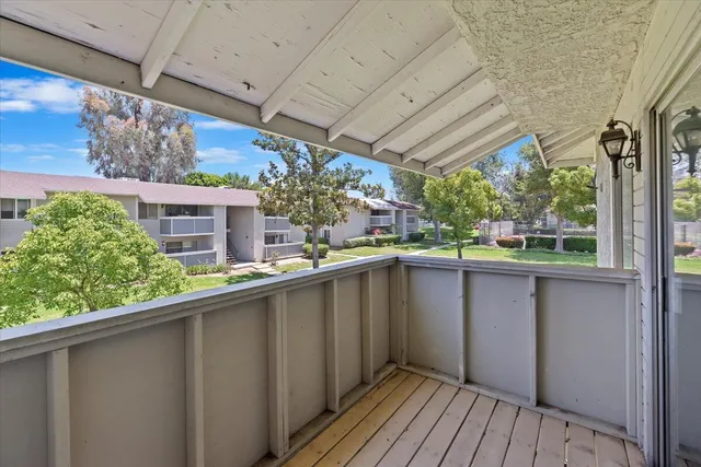 a view of balcony with wooden floor