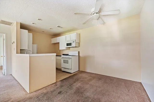 a view of a kitchen with electric appliances