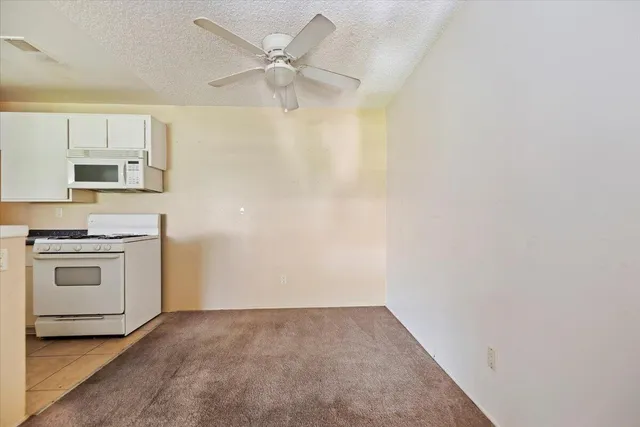a view of a kitchen with a sink and a stove top oven