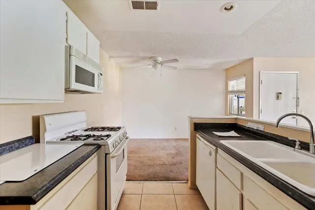 a kitchen that has a sink and a stove