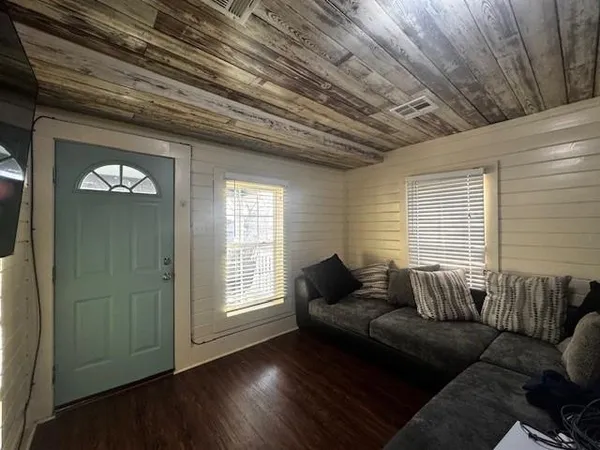 a living room with furniture and wooden floor