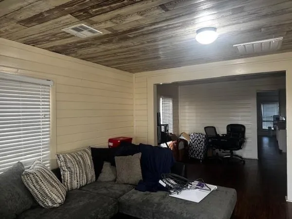 a view of a livingroom with furniture and a window