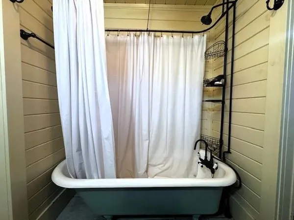 a bathroom with a toilet and a shower