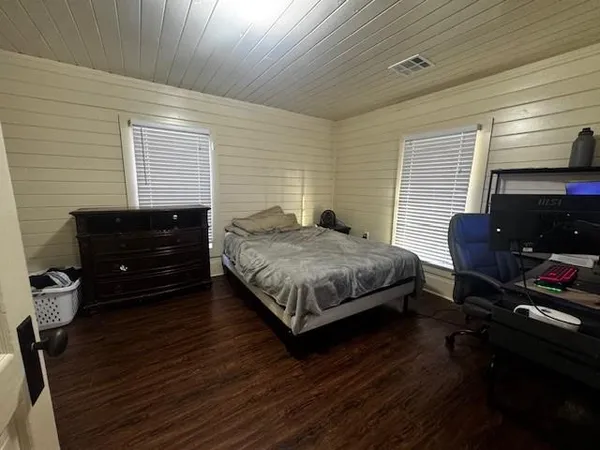 a house is sitting in middle of the forest