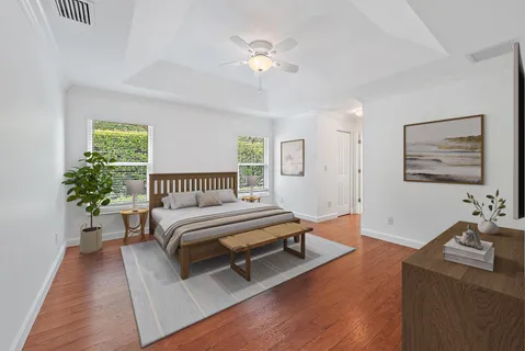 a spacious bedroom with a bed and a chandelier