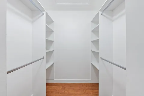 a view of staircase with white walls and door