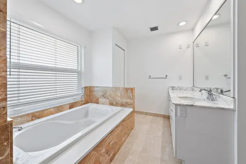 a bathroom with a bathtub and a sink