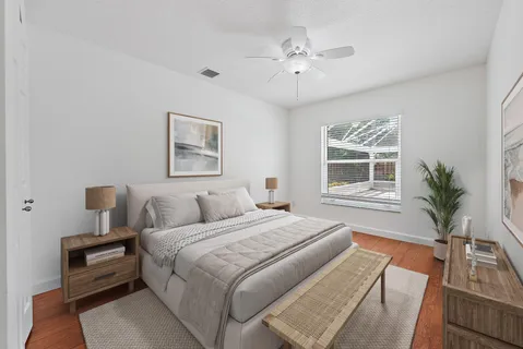a bedroom with a large bed and a chandelier