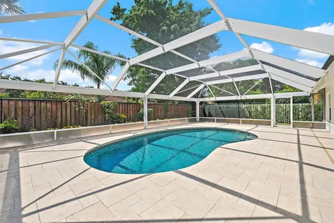 a view of a backyard with a swimming pool