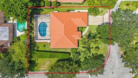 an aerial view of a house with a yard basket ball court and outdoor seating