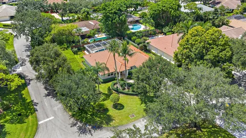 an aerial view of a house with a yard and garden