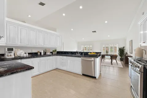 a kitchen with a sink and white cabinets