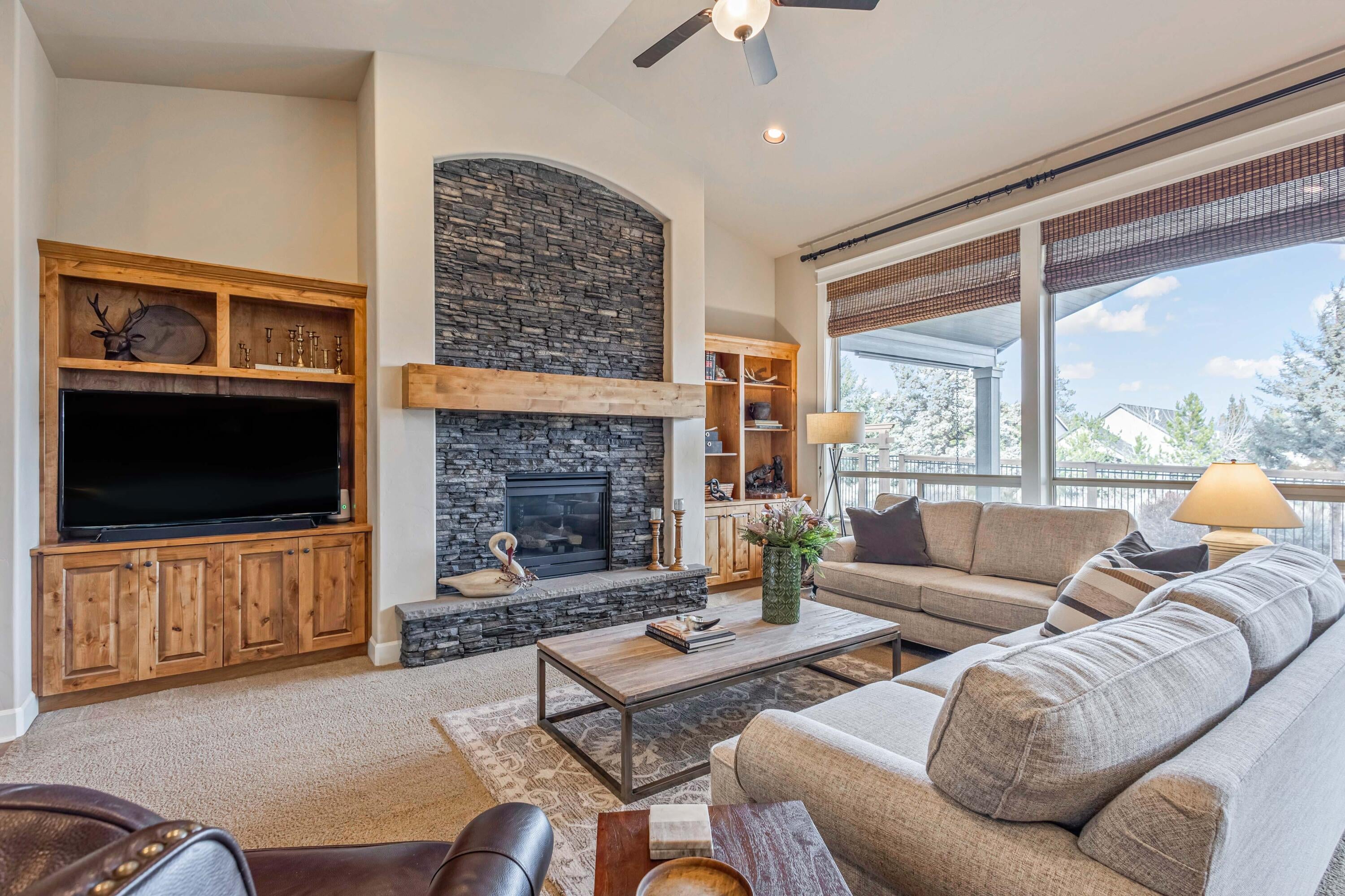 Great room with stone surround gas fireplace and custom built-ins.