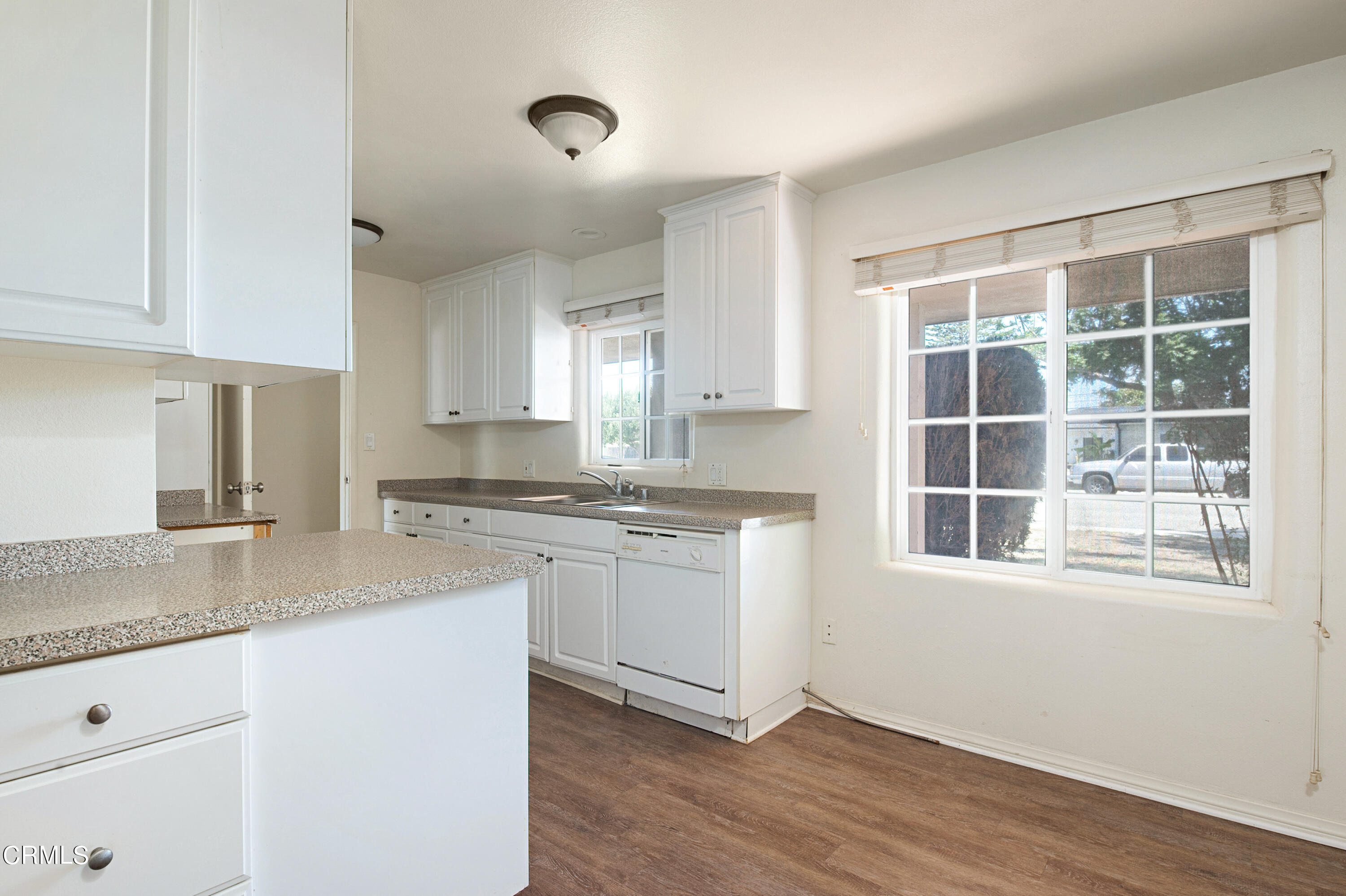 458 West Roderick Avenue Oxnard, CA 93030 - Photo 4 of 18 a kitchen with a granite countertop sink window and cabinets