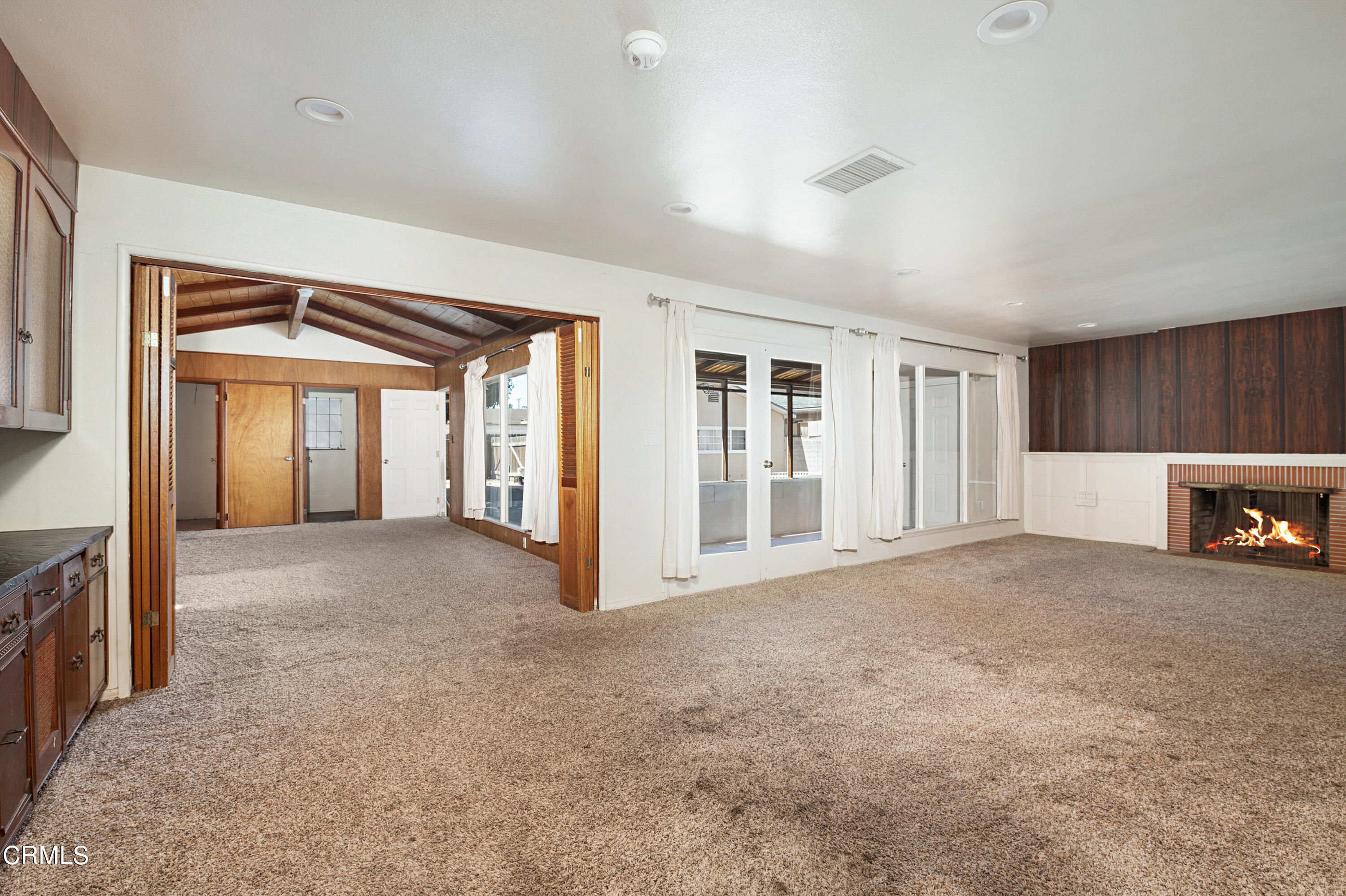 458 West Roderick Avenue Oxnard, CA 93030 - Photo 6 of 18 a view of an empty room with a fireplace and a window