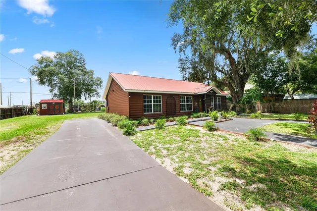 a front view of house with yard and green space