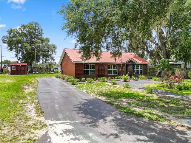 a front view of a house with a yard table and chairs