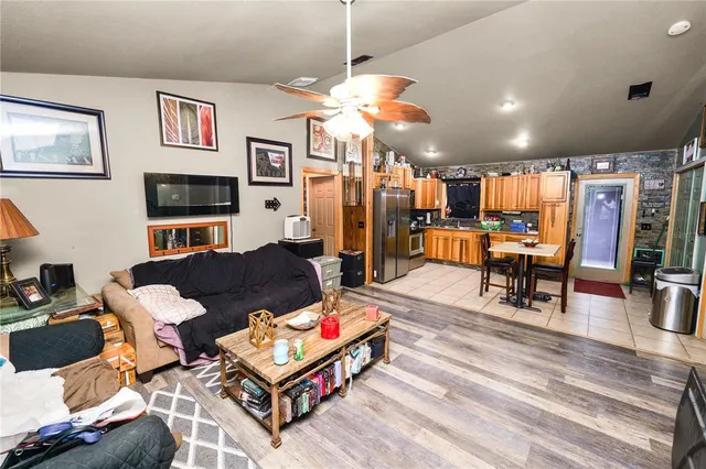 a living room with furniture a dining table and a fireplace
