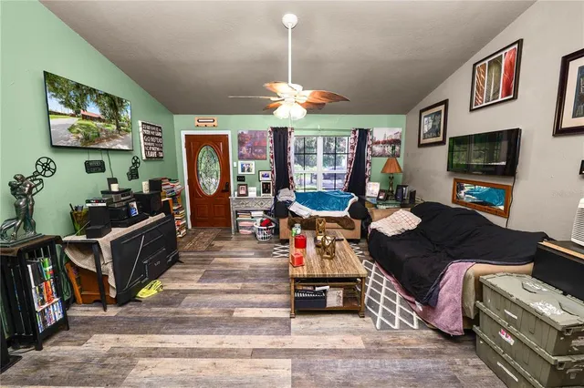 a living room with furniture a flat screen tv and a dining table