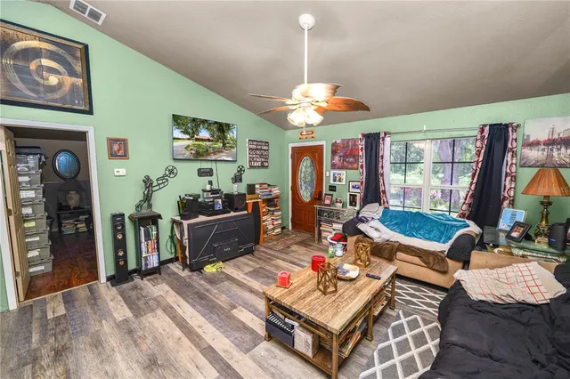 a living room with fireplace furniture and a flat screen tv