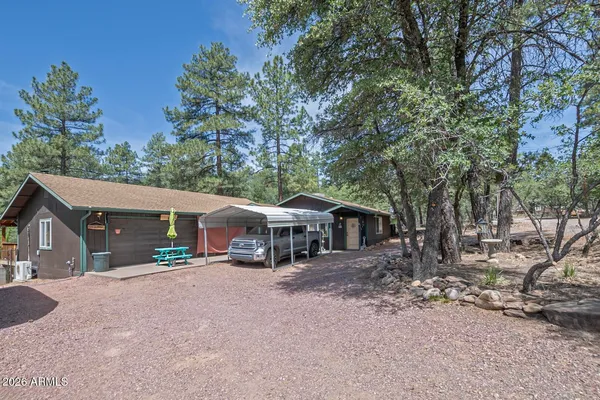 a view of a house with a yard and sitting area