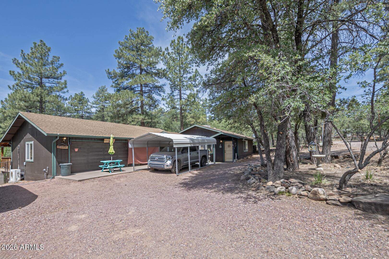 a view of a house with a yard and sitting area