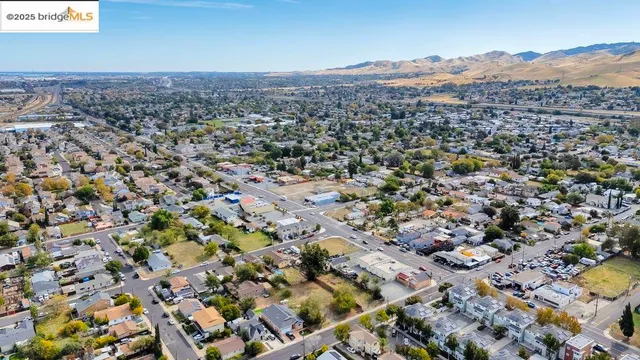 an aerial view of a house with a yard and greenery