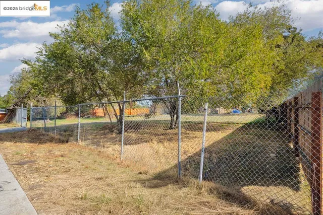 a backyard of a house with large trees