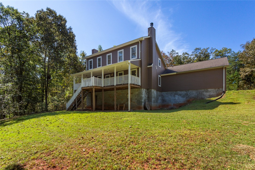 621 Burns Mill Road West Union, SC 29696 - Photo 31 of 45 A spacious home nestled amongst mature trees features a large yard and covered porch.