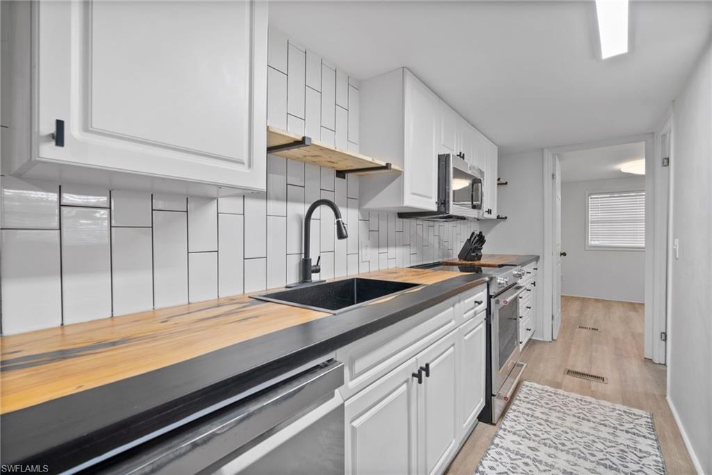 26222 Earl Road Bonita Springs, FL 34135 - Photo 12 of 23 a kitchen with a sink and cabinets