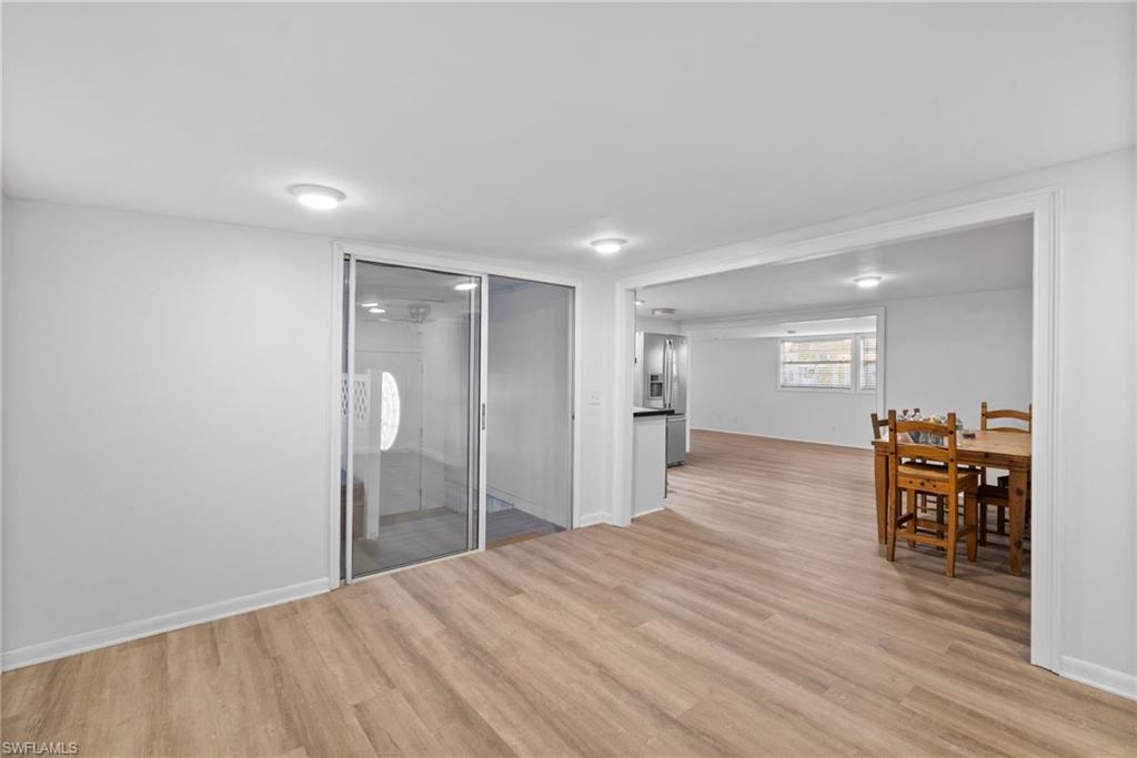 26222 Earl Road Bonita Springs, FL 34135 - Photo 16 of 23 a view of a room with wooden floor furniture and windows
