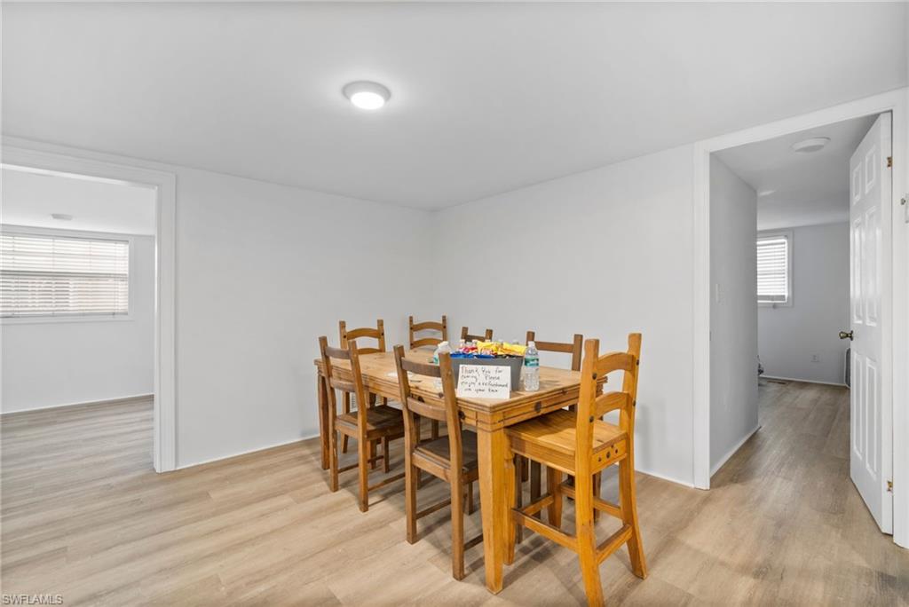 26222 Earl Road Bonita Springs, FL 34135 - Photo 3 of 23 a view of a dining room with furniture and wooden floor