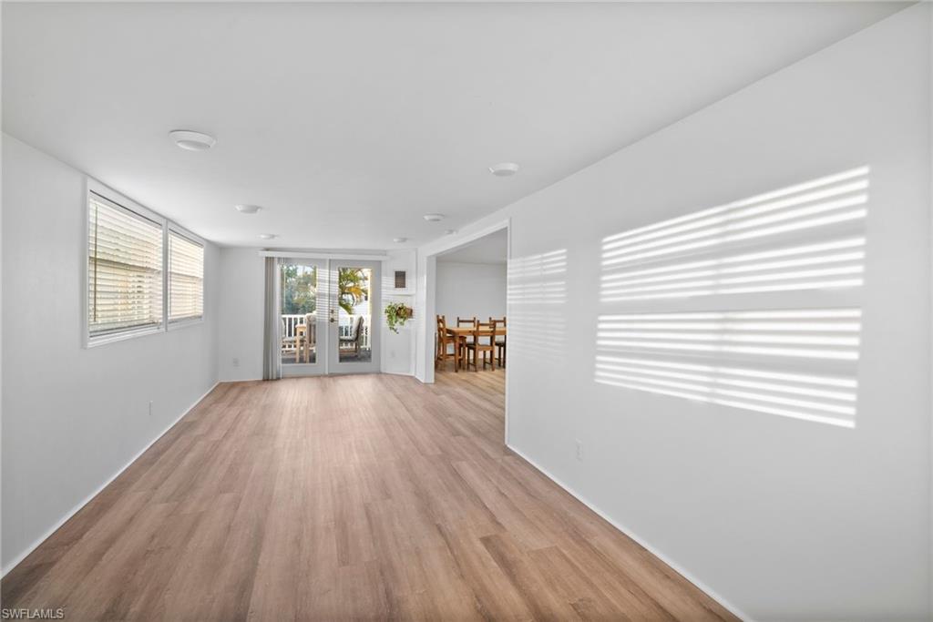 26222 Earl Road Bonita Springs, FL 34135 - Photo 6 of 23 a view of an empty room with wooden floor and a window