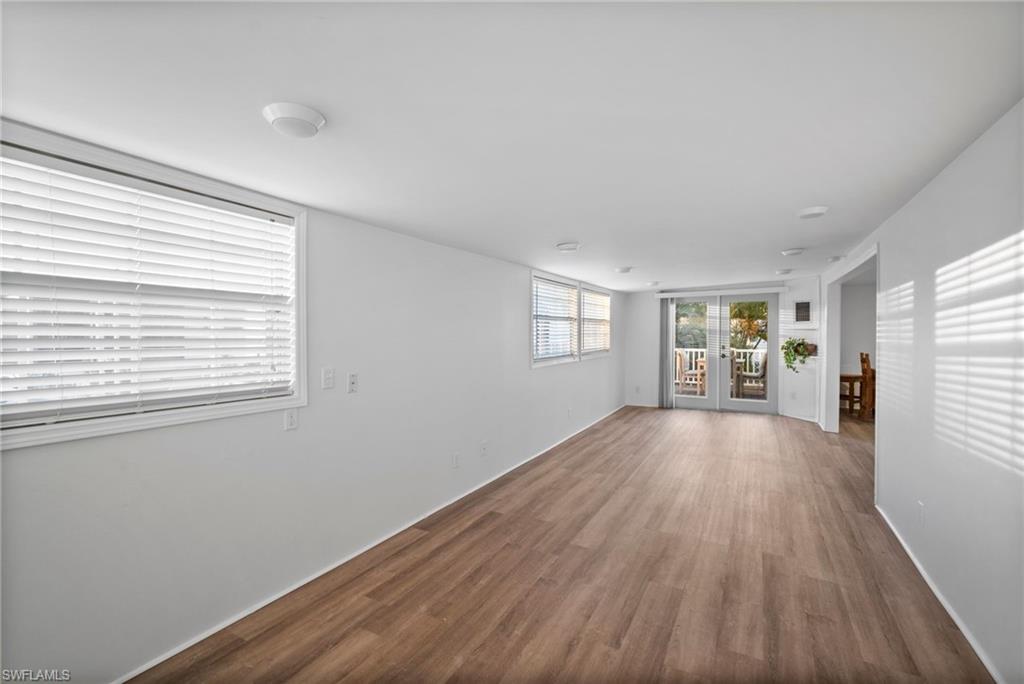 26222 Earl Road Bonita Springs, FL 34135 - Photo 8 of 23 a view of an empty room with wooden floor and a window