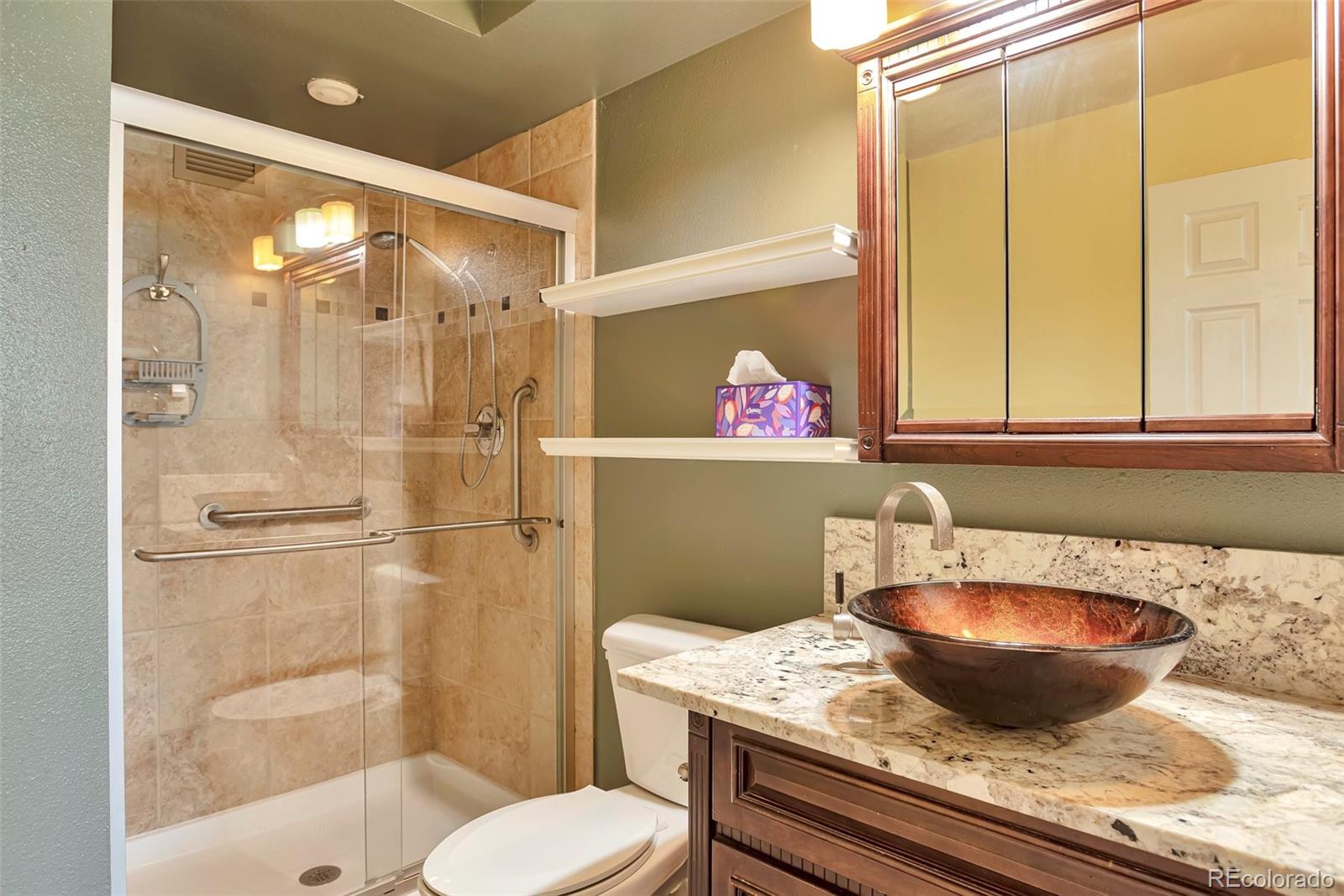 650 South Clinton Street, Unit 3A Denver, CO 80247 - Photo 14 of 25 a bathroom with a granite countertop sink toilet a mirror and shower