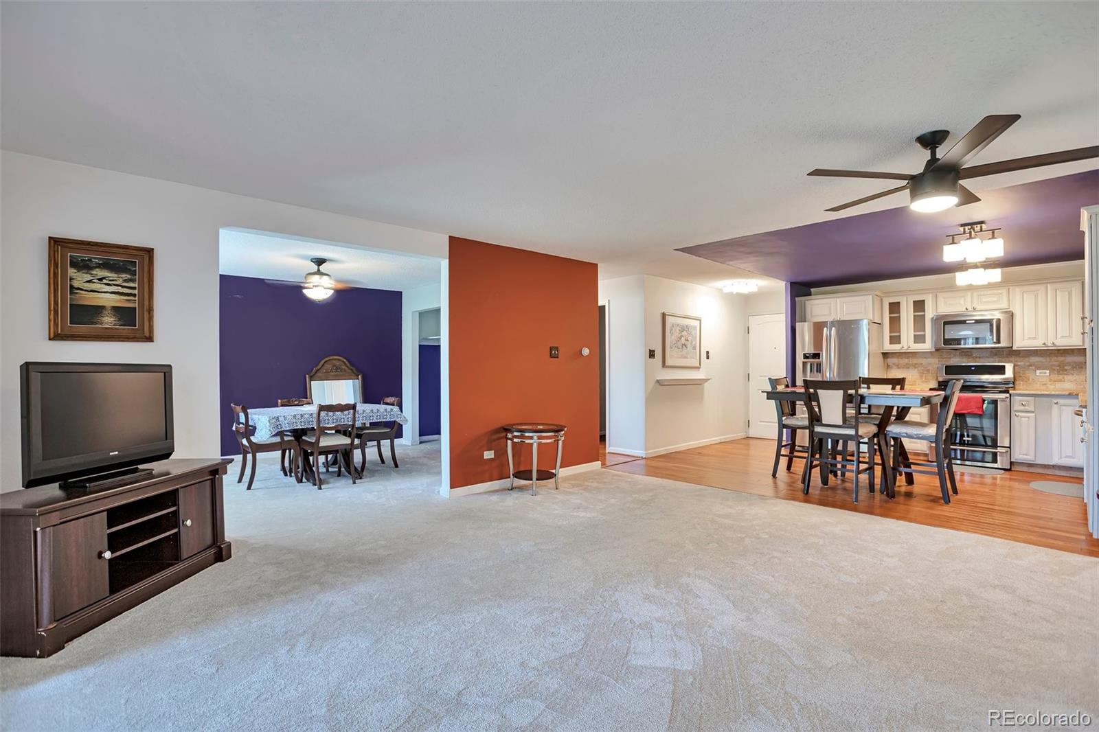 650 South Clinton Street, Unit 3A Denver, CO 80247 - Photo 18 of 25 a view of a livingroom with furniture and a flat screen tv